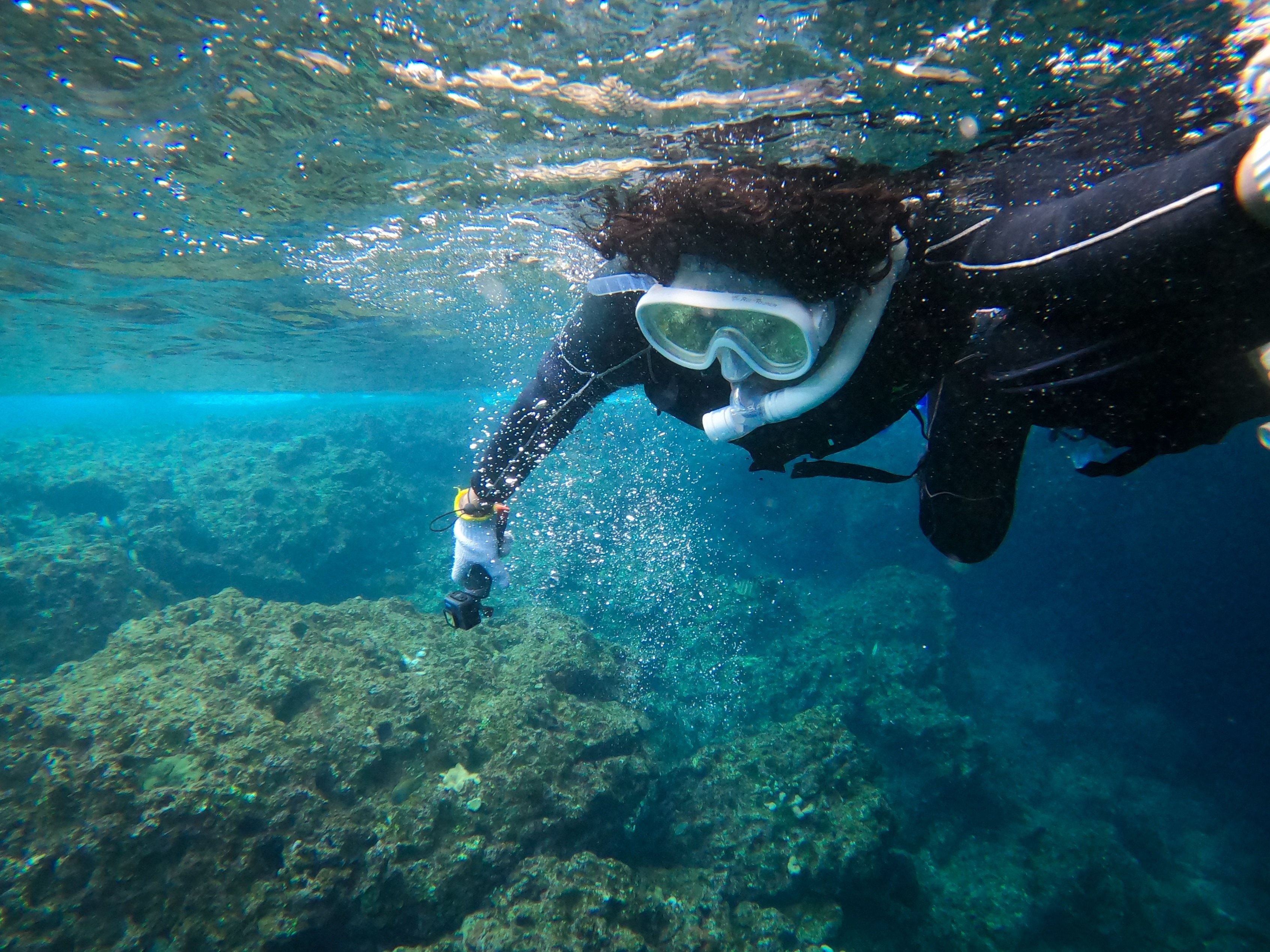 Dulanga Jayawardena snorkeling in the clear blue waters of Okinawa